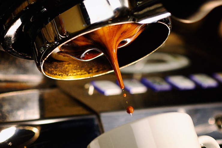 Espresso brewing, with a dark reddish-brown foam, called crema.